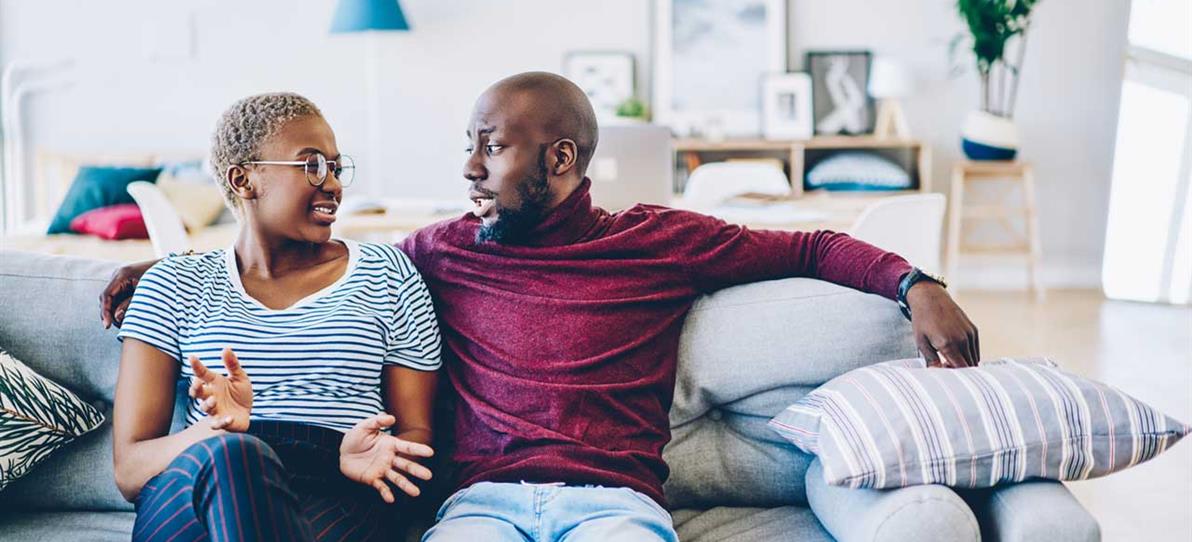 Couple talking on couch
