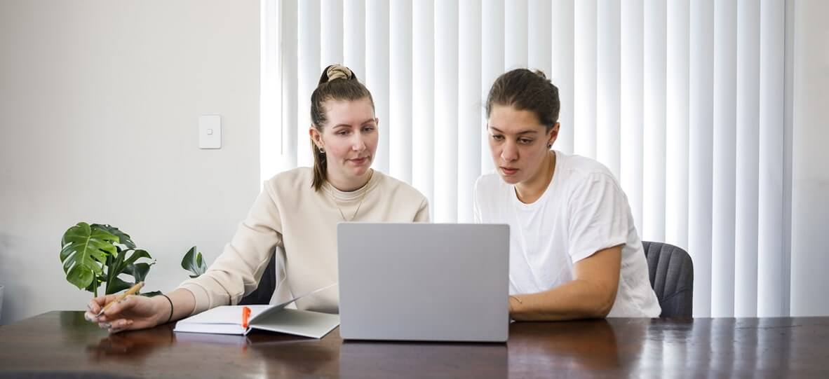 women in front of a laptop