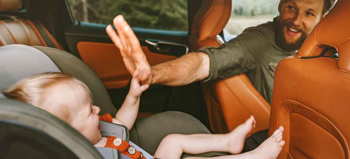 Father and baby in car