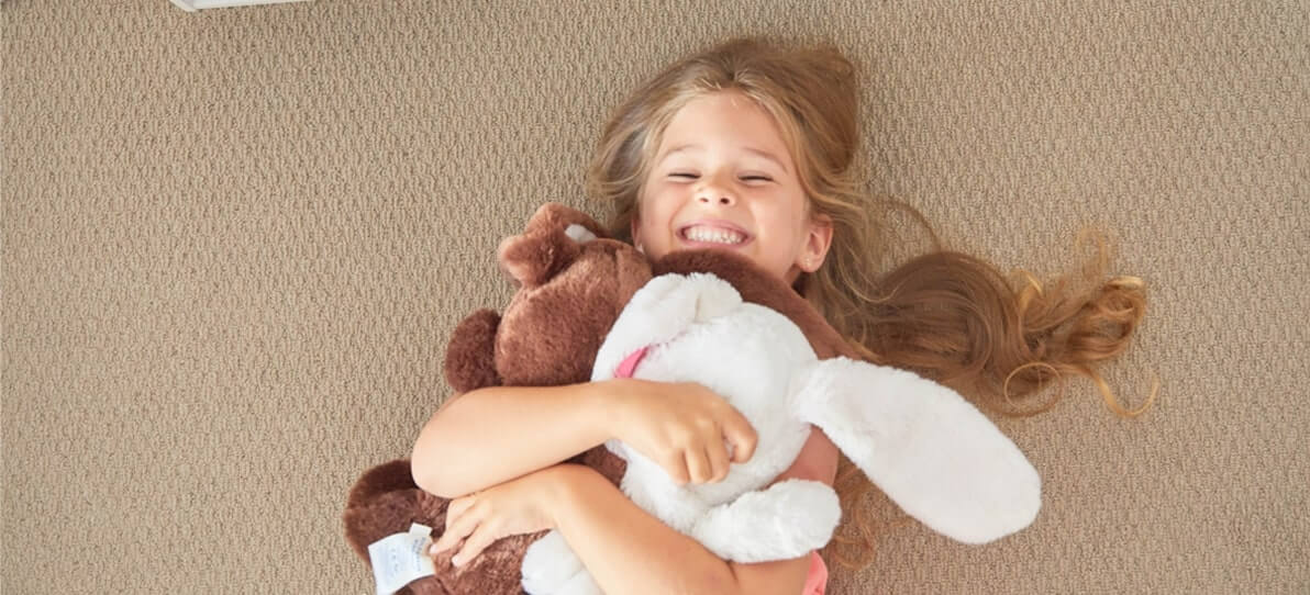 girl playing with teddies